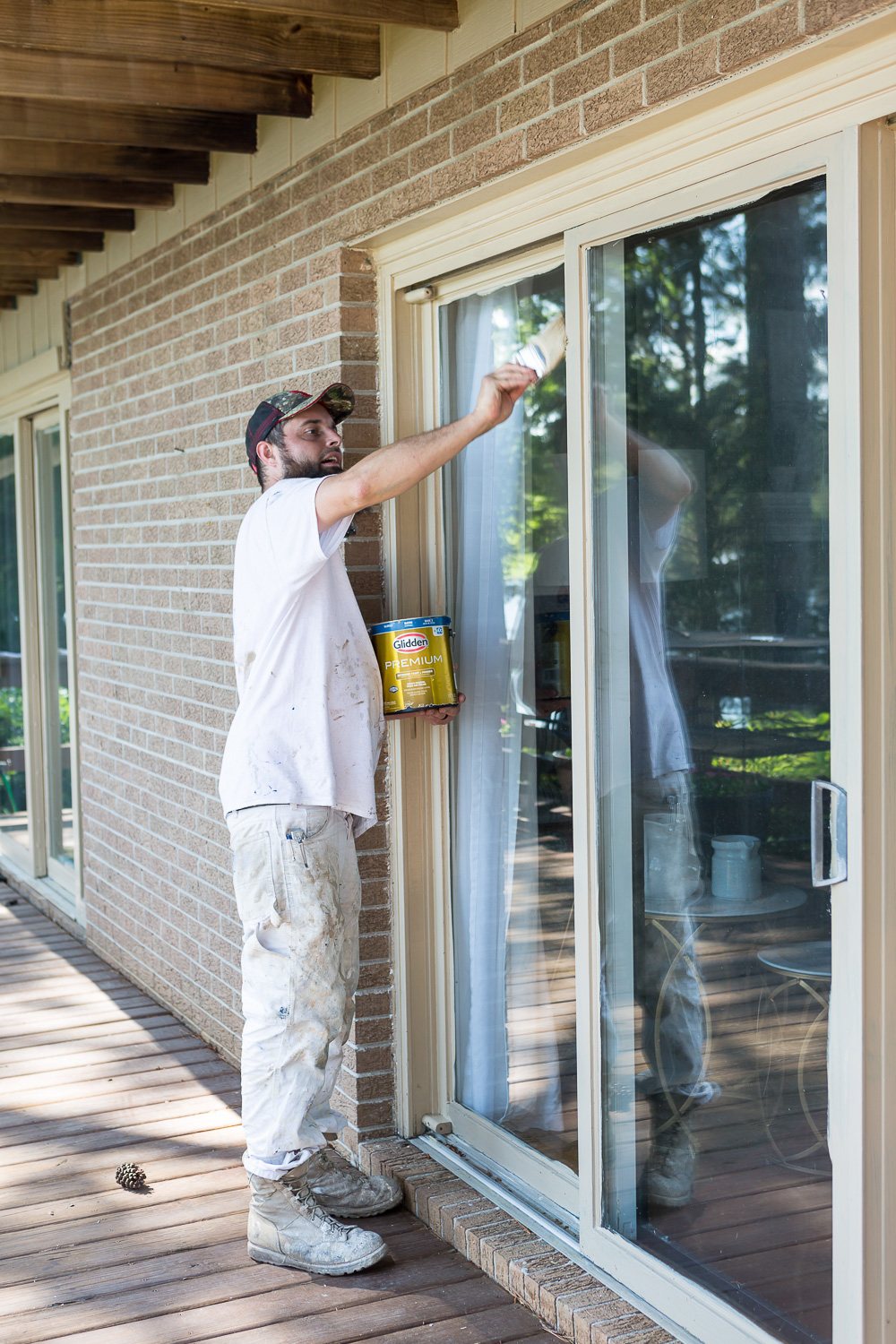 Painter painting trim with Glidden Premium paint and primer in one