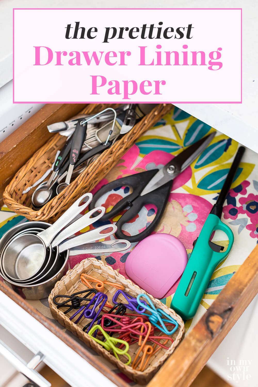 Colorful floral drawer liner in kitchen drawer. Text over lay says The prettiest drawer lining paper