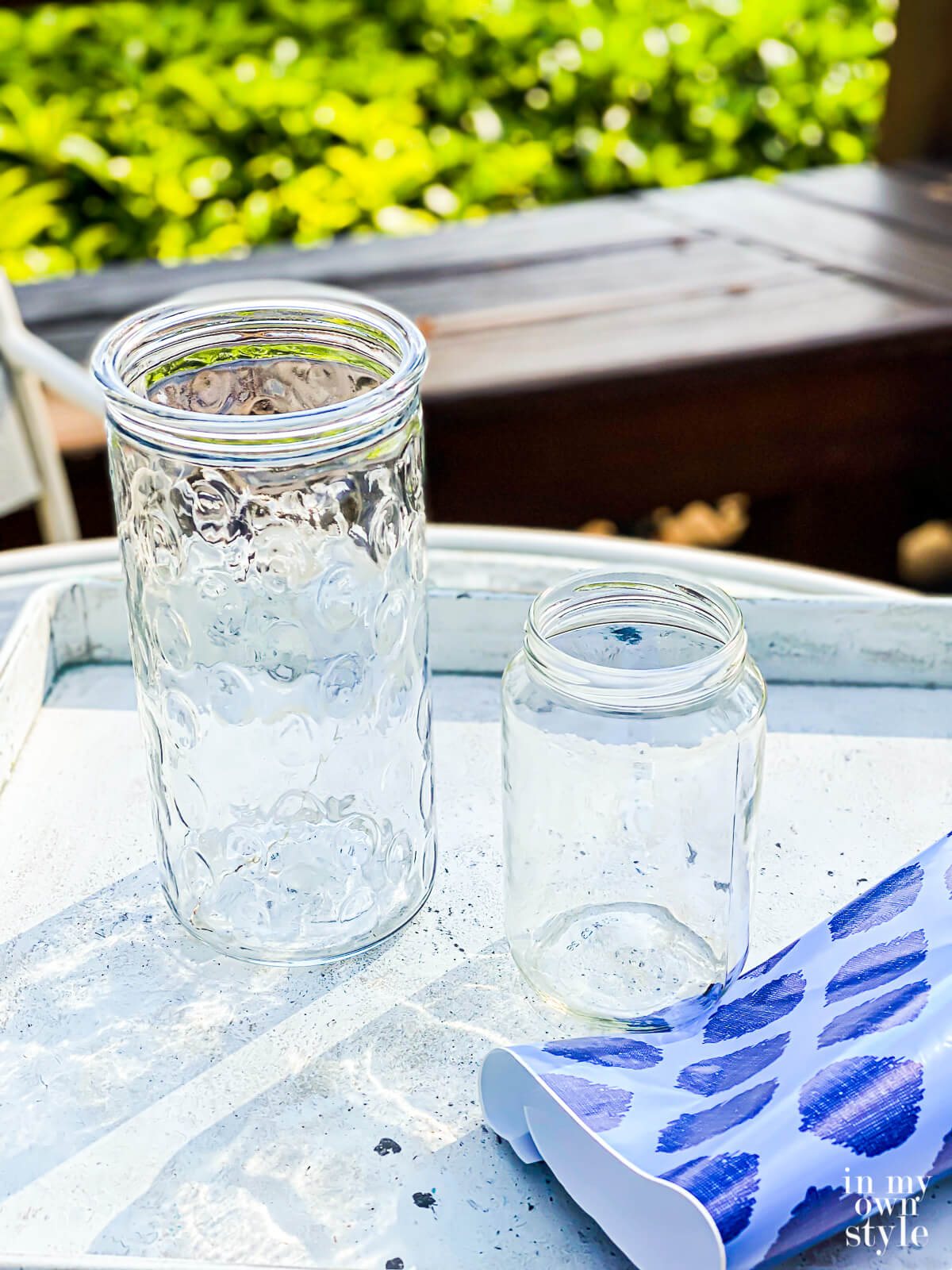 a glass vase, a jar and a piece of gift wrap.