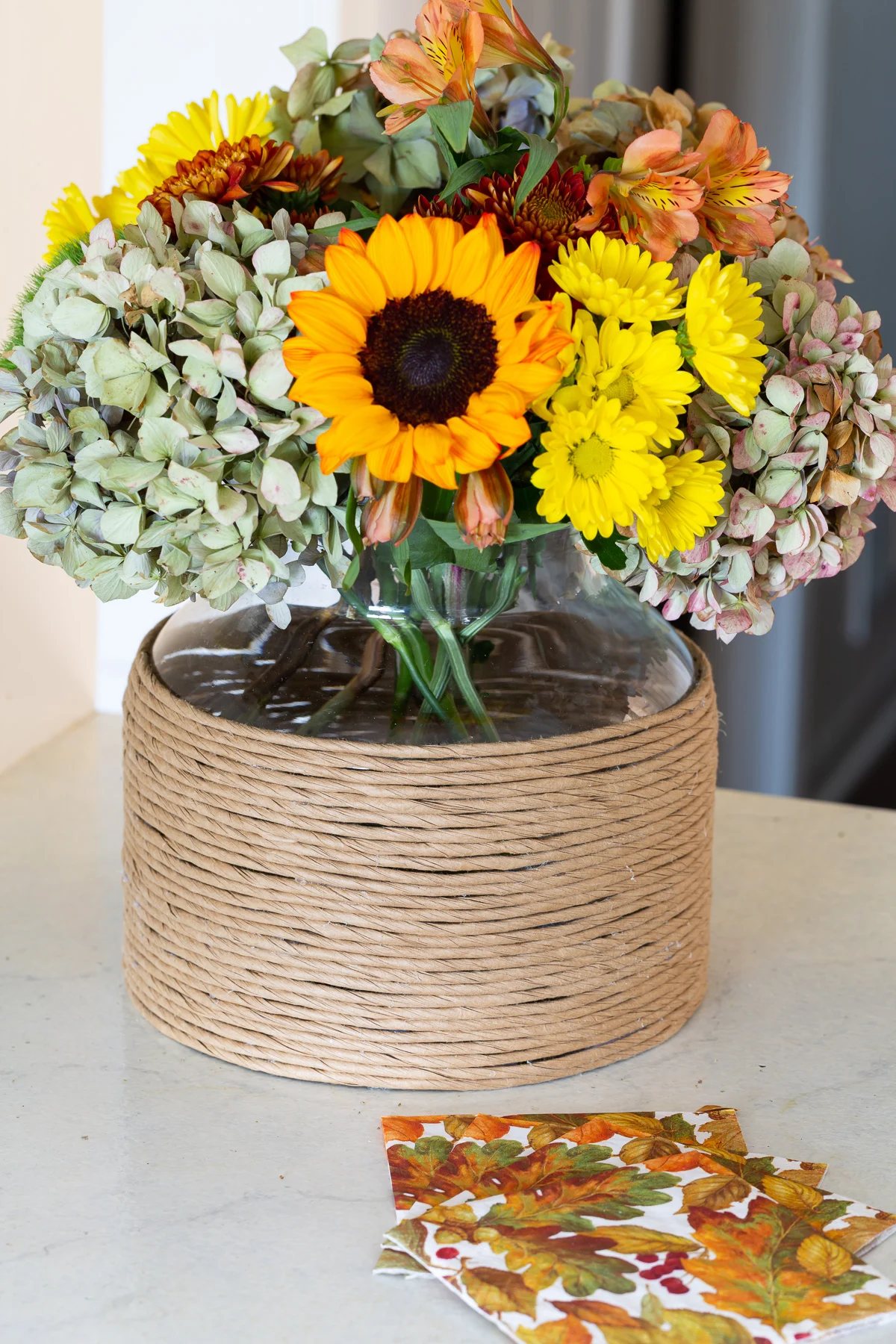 fall flowers in paper cord wrapped vase