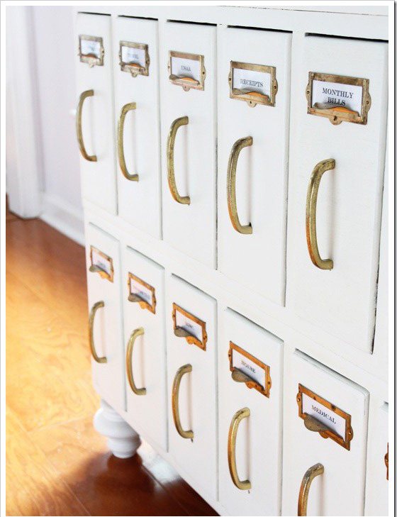Library drawers made over with white chalk paint and brass hardware.
