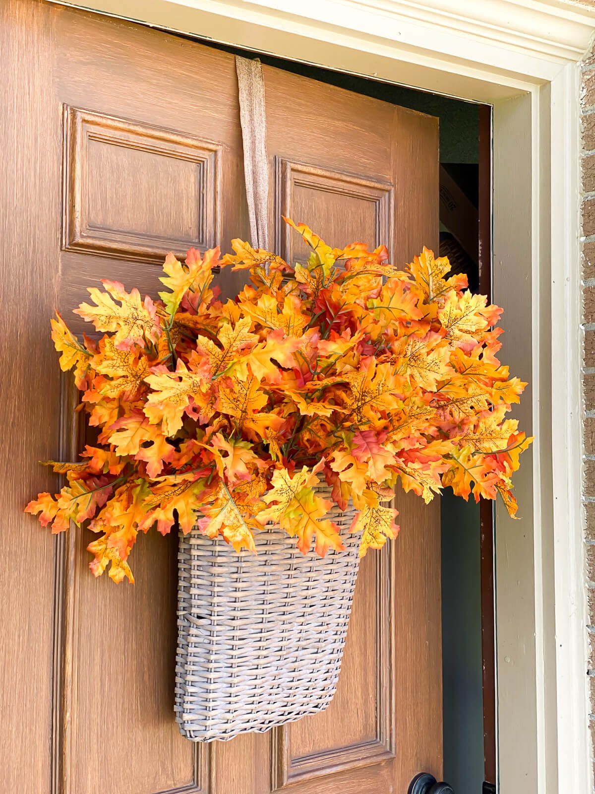 flat back basket for door filled with fall leaves