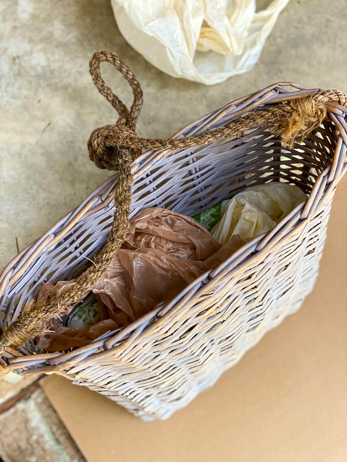 flat back basket for door filled with plastic bags