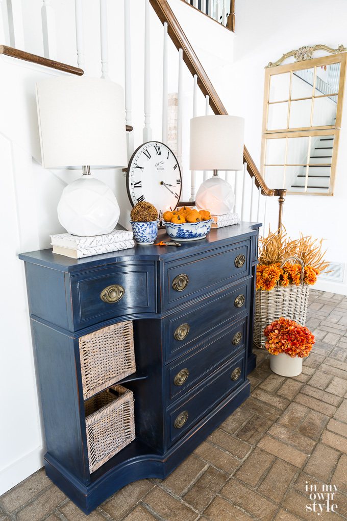 Blue sideboard in foyer all decked out for fall.