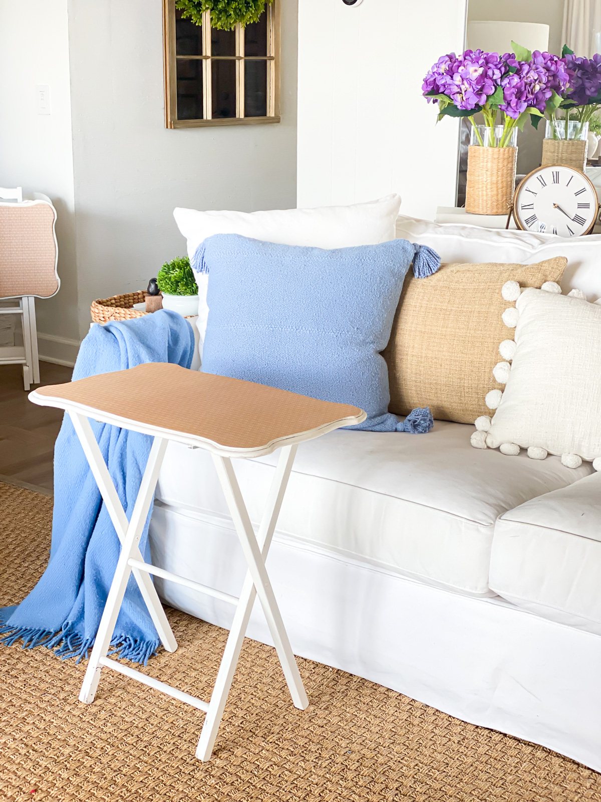 Old white tray table gets a makeover using wallpaper.
