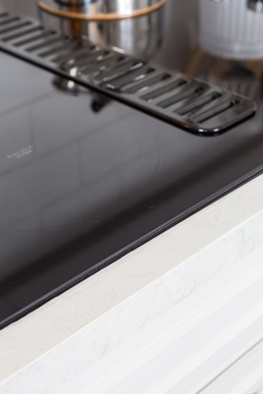 Kitchen-Black-glass-cooktop in white kitchen