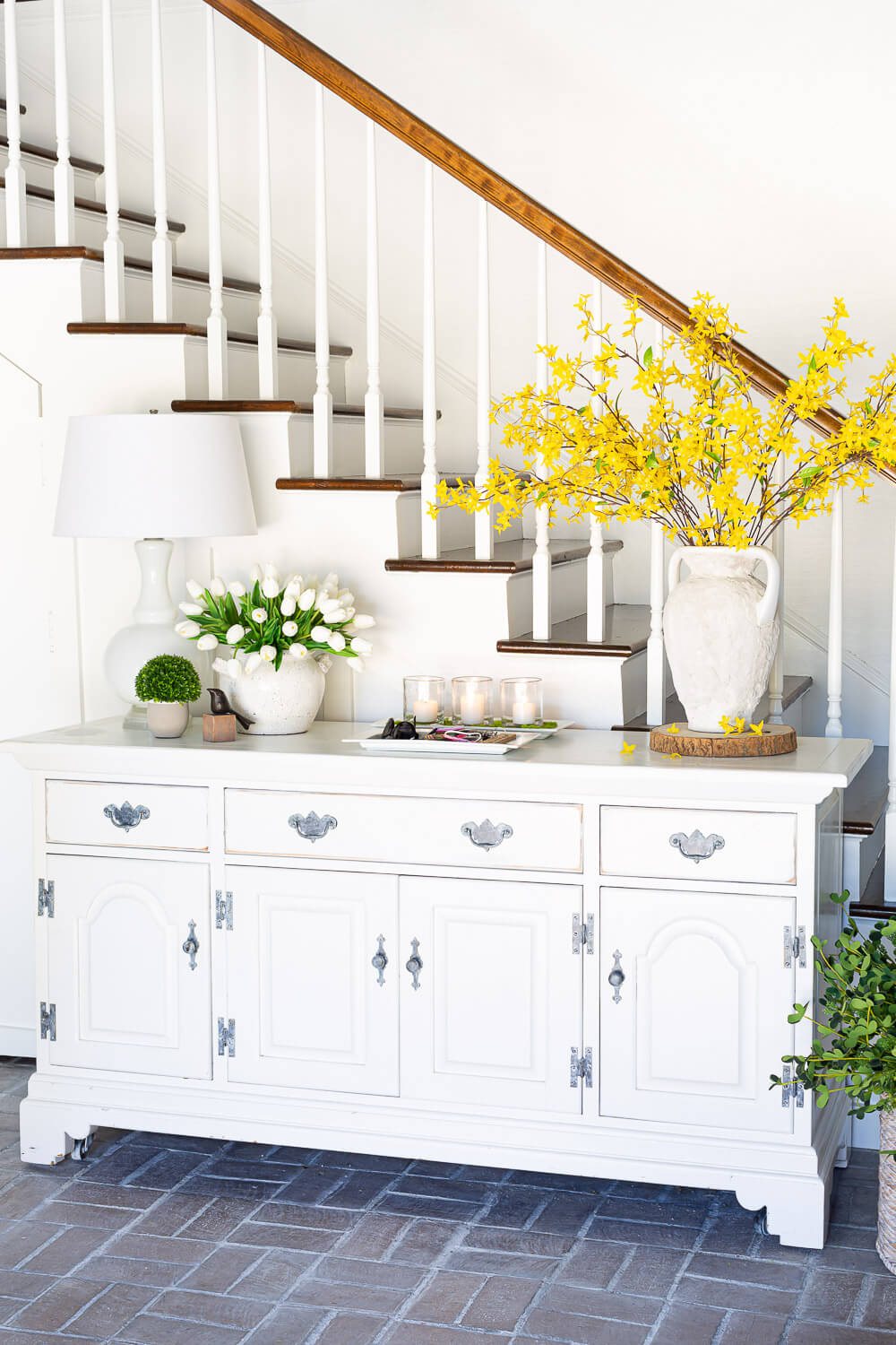 White dresser in foyer decorated for spring.