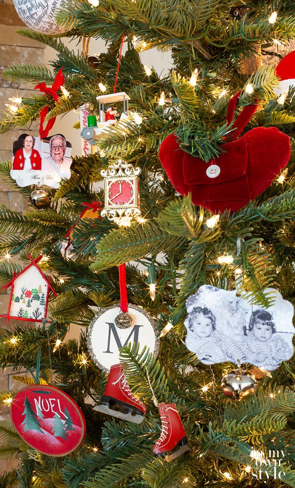 Close up of red Christmas tree ornaments on the tree. Some handmade. Others purchased.
