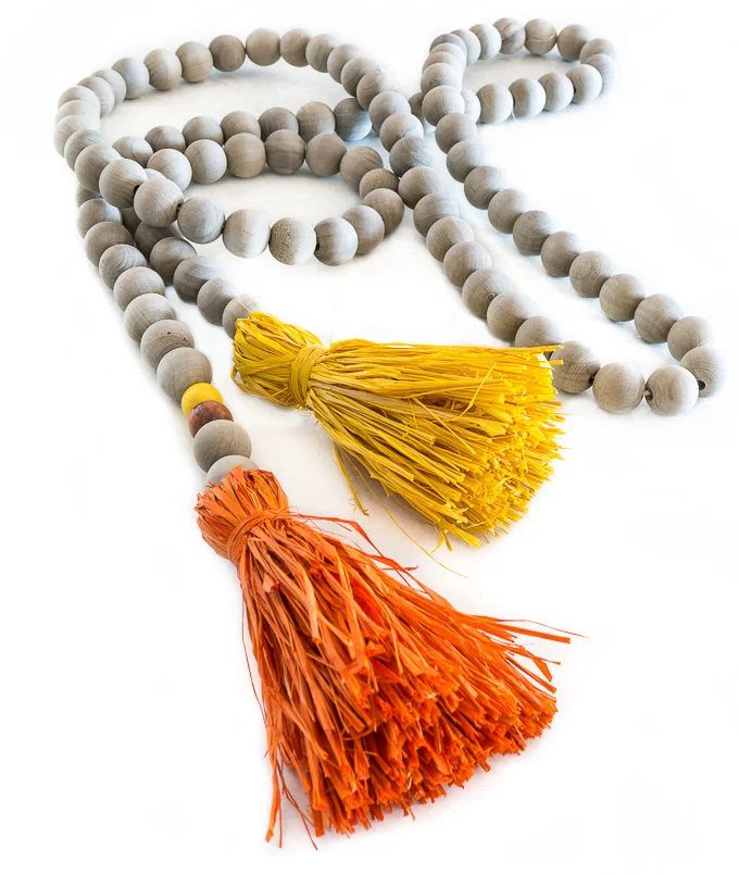 Driftwood stained Wood bead garland with colorful raffia tassels