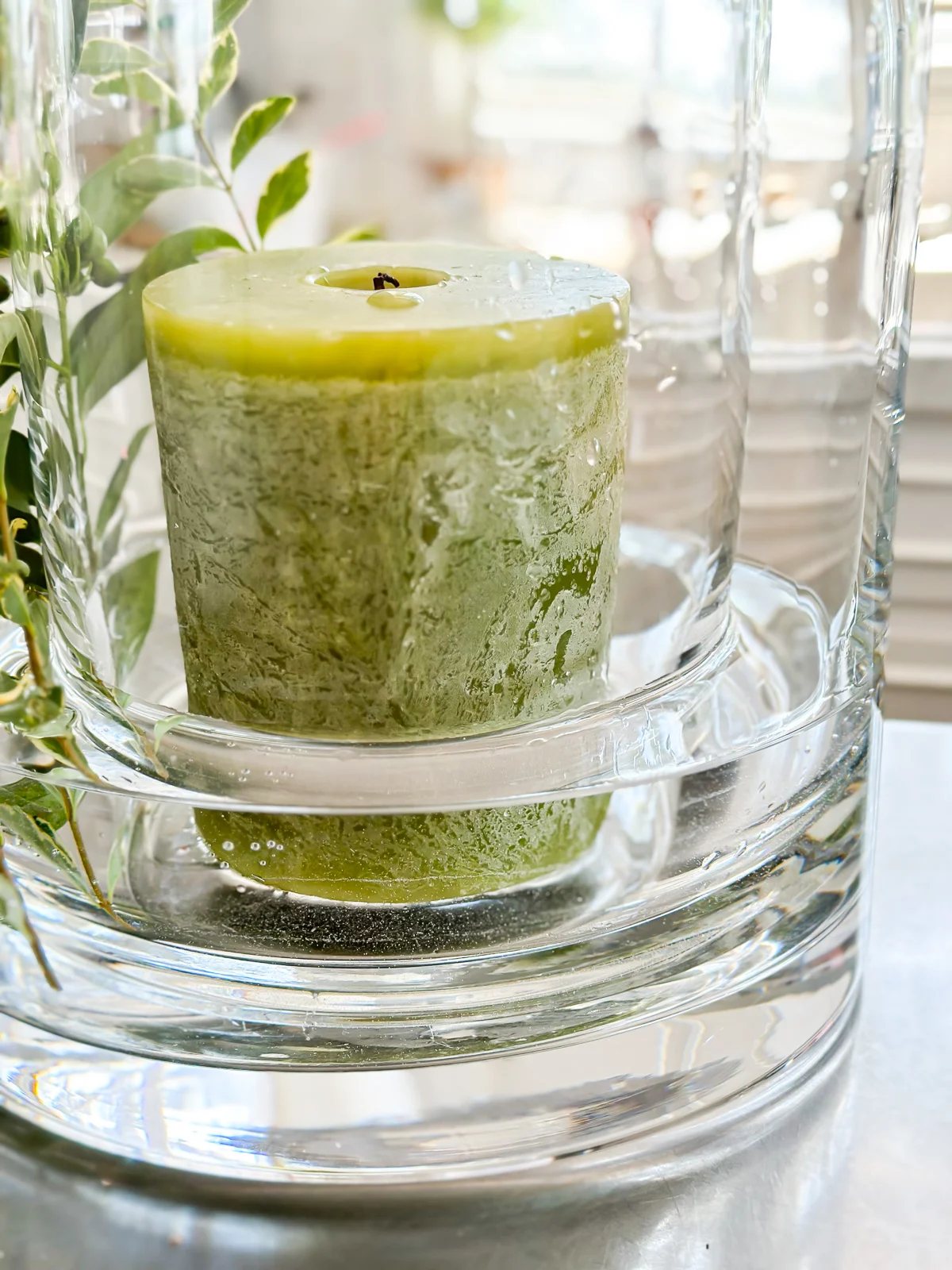 A smaller cylinder glass vase inside a larger one. Fill large vase with water and add a candle.