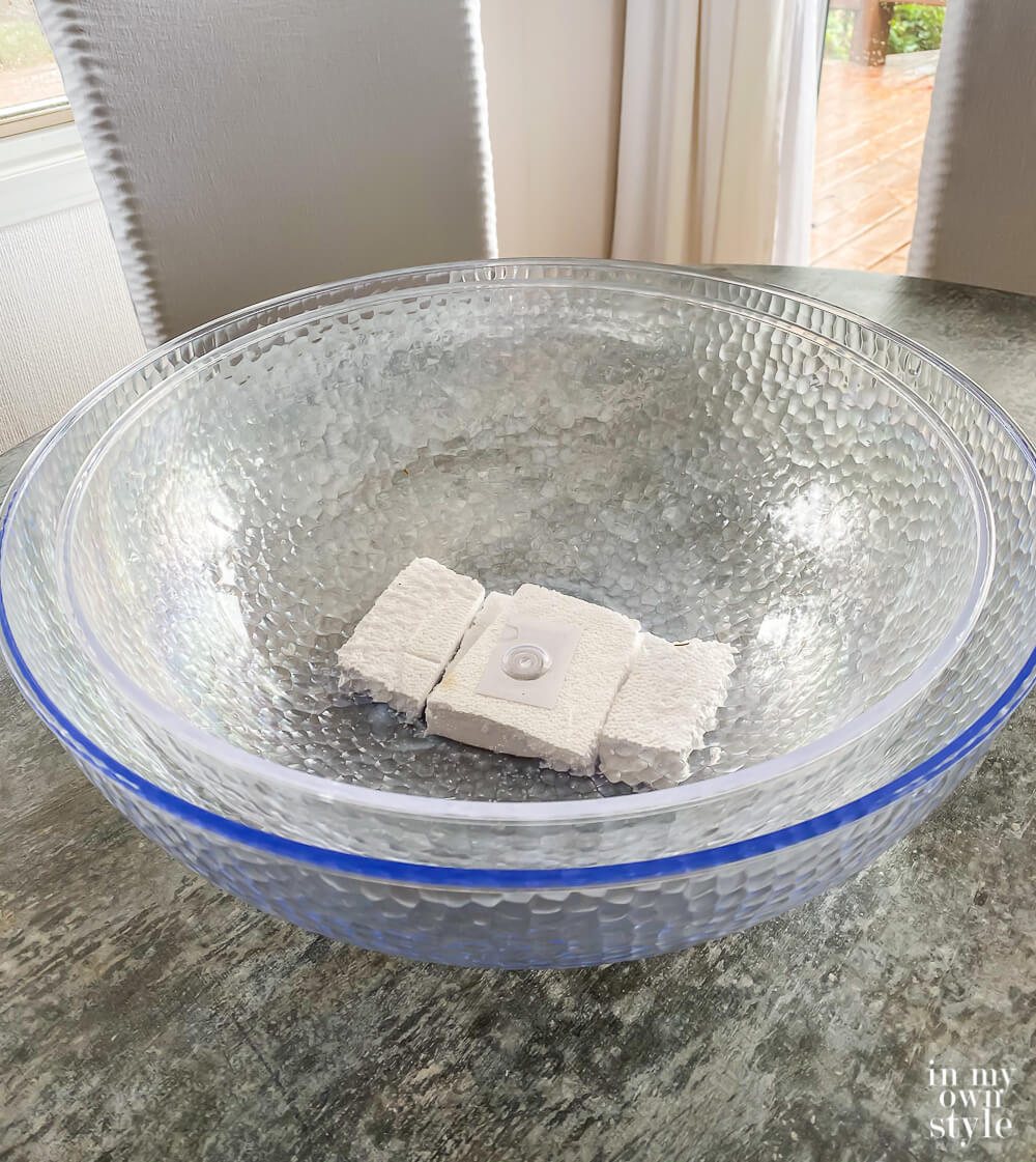 Smaller bowl placed inside large bowl with Styrofoam blocks under small bowl.