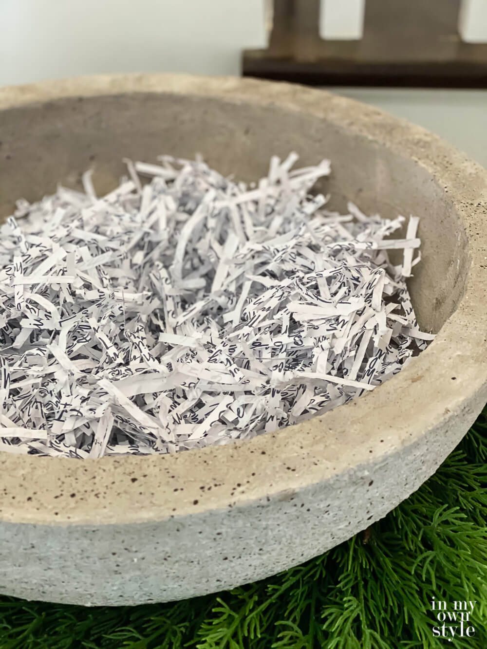 Shredded paper in a faux cement look large bowl.