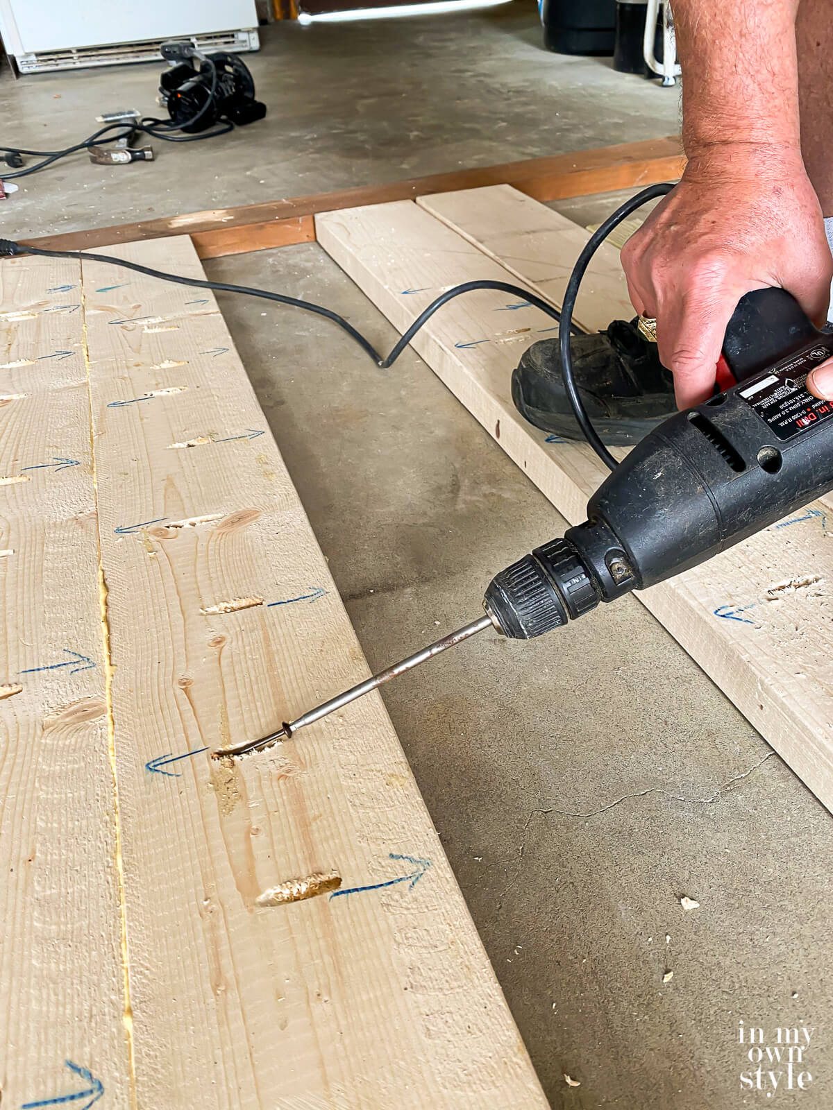 Adding wood screws into pocket holes on under side of wood boards.