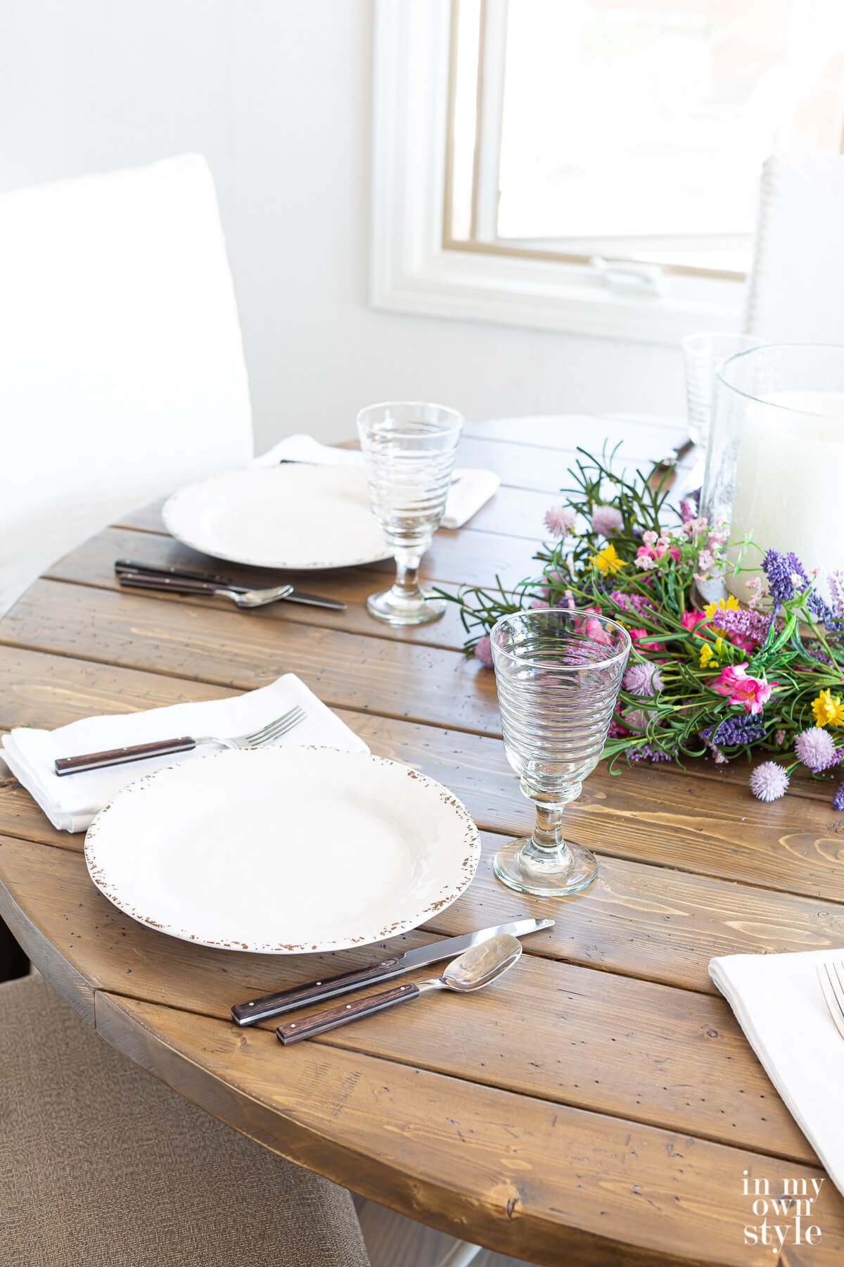 Completed DIY round wood table top set for dinner.