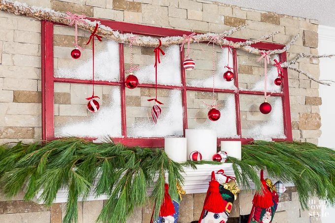Christmas mantel decorating idea that uses an old window sash and tree branch.