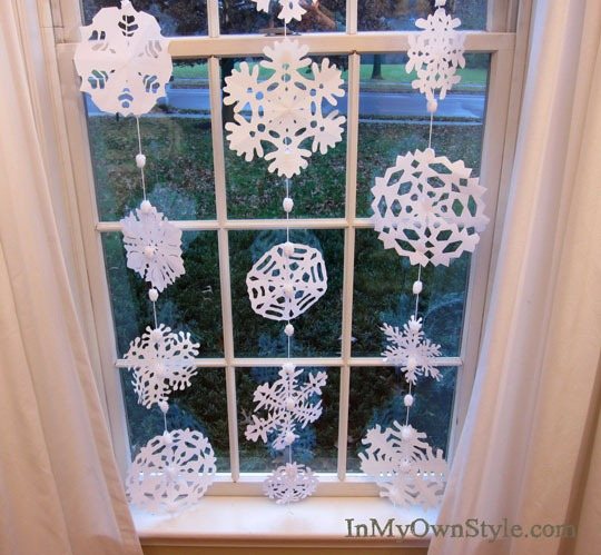 paper snowflakes hanging in a window