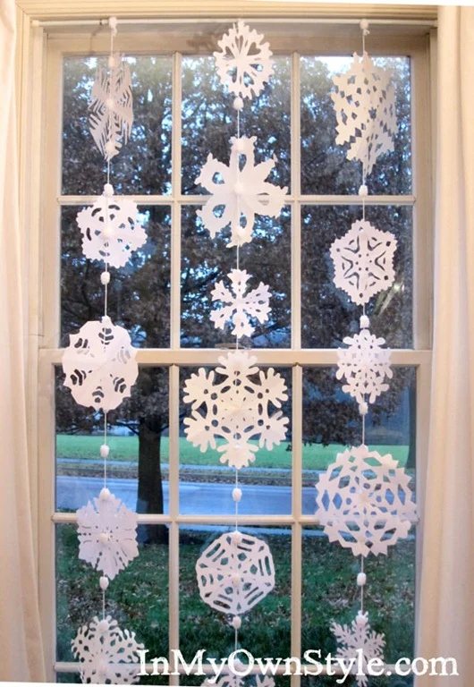 Paper snowflakes hanging in a window