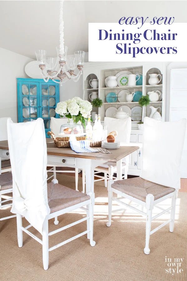 dining room with white chairs and white DIY made slipcovers