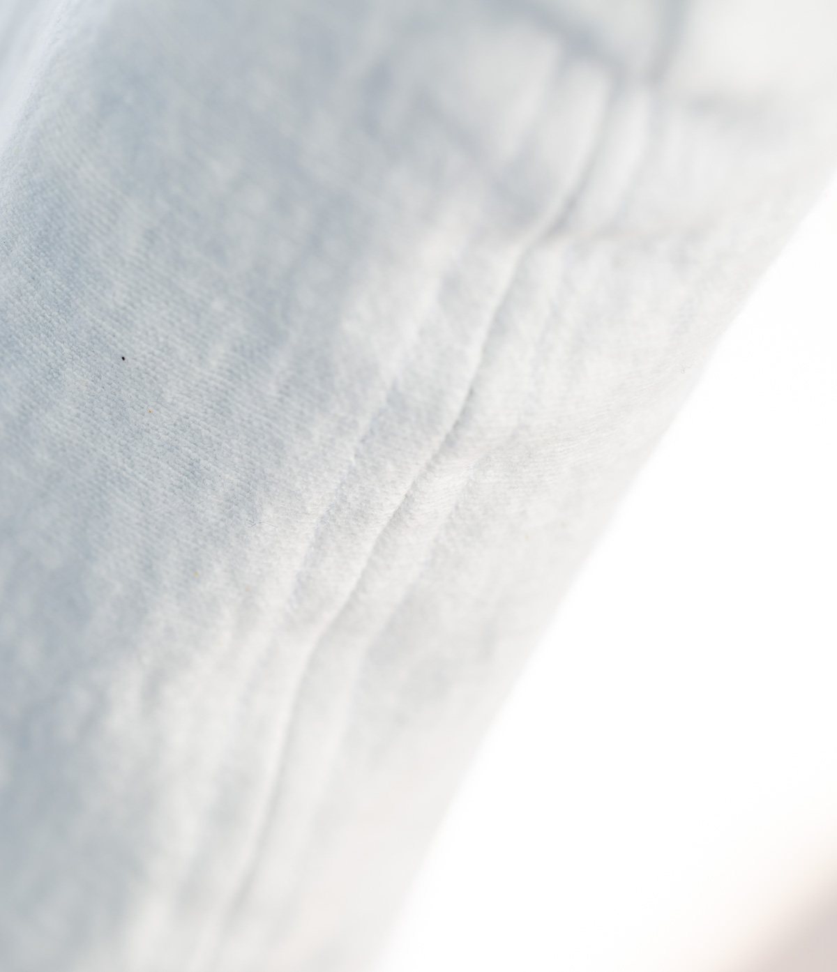 closeup of seam sewn on a diy dining room chair slipcover.