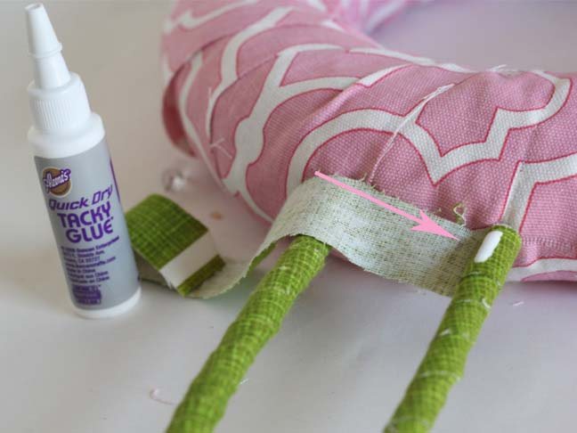 How to secure end of fabric to plastic hangers to make bunny ears on wreath.