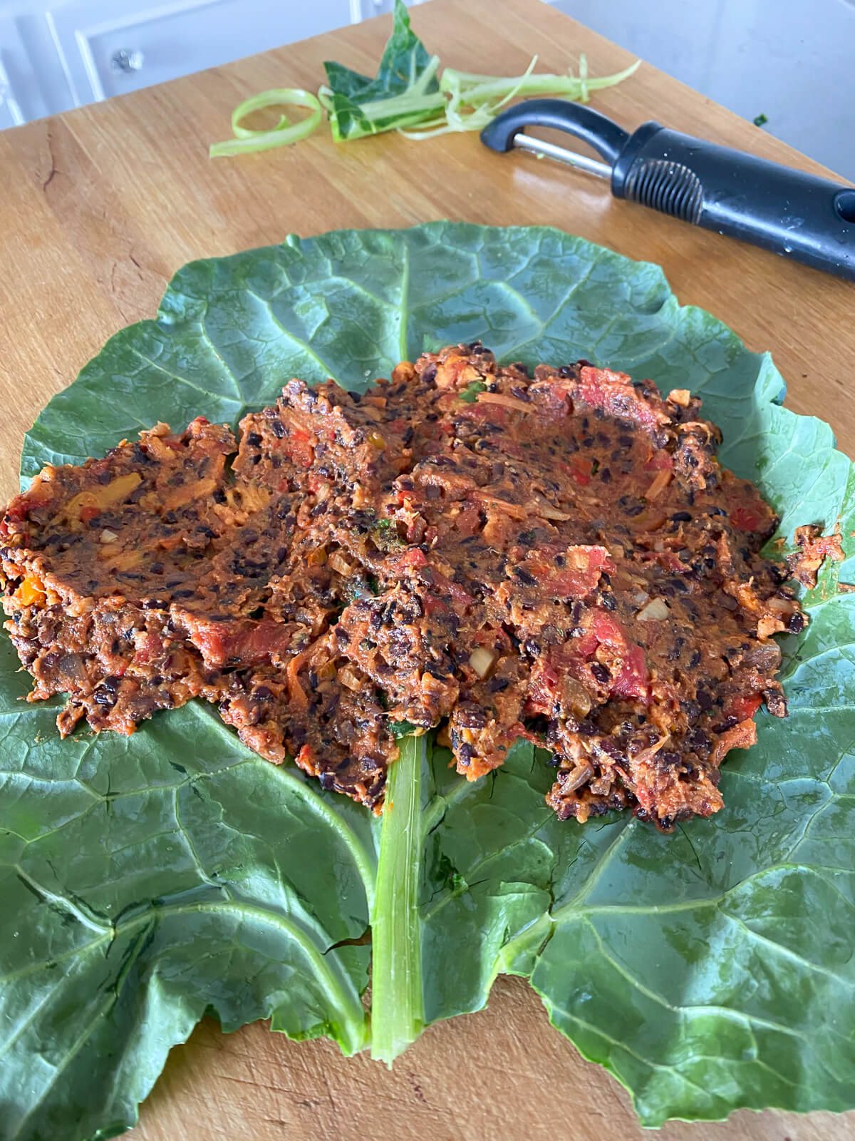 collard green wrap being made using a vegan filling