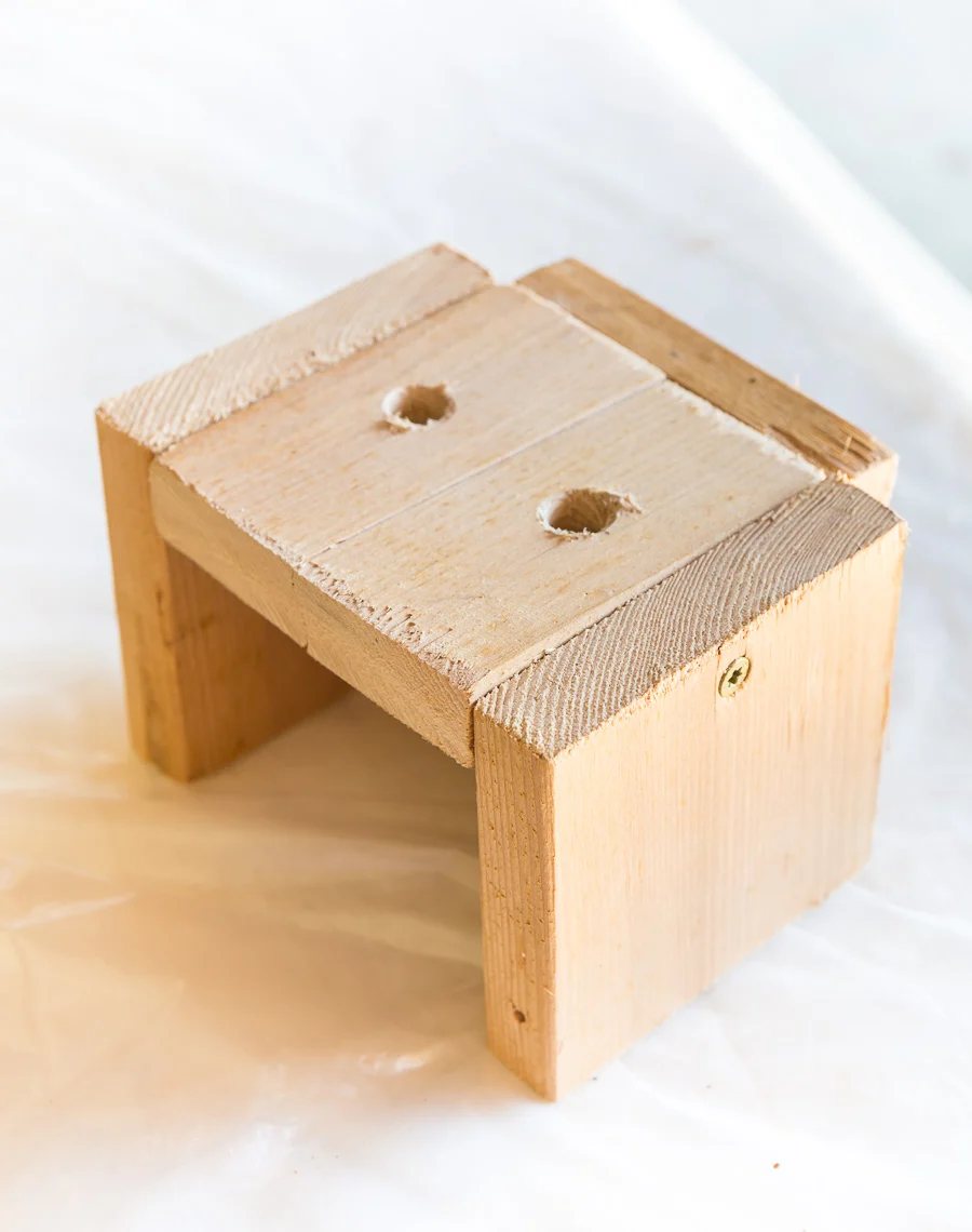 wood jig to use when drilling holes into the end of boards to create a modern wood slat accent wall