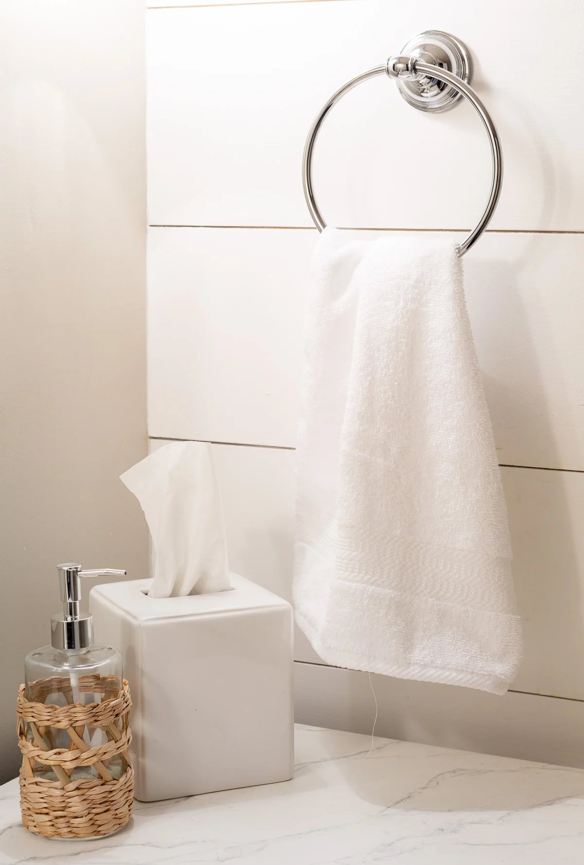 white bath towel on towel ring in bathroom