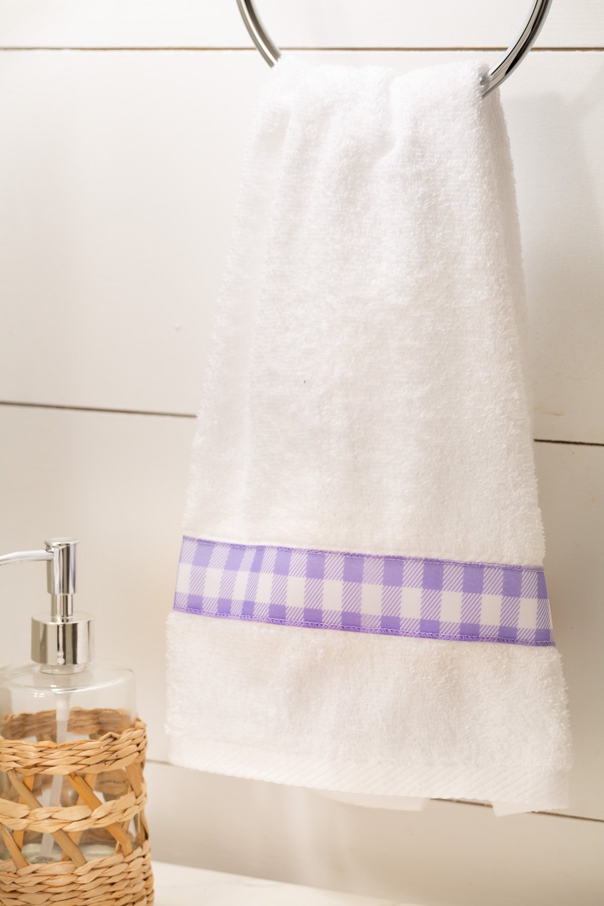white towel with lavender and white check ribbon trim.