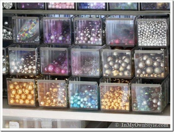 colorful beads in storage drawers that will be make into drop earrings and dangle earrings.