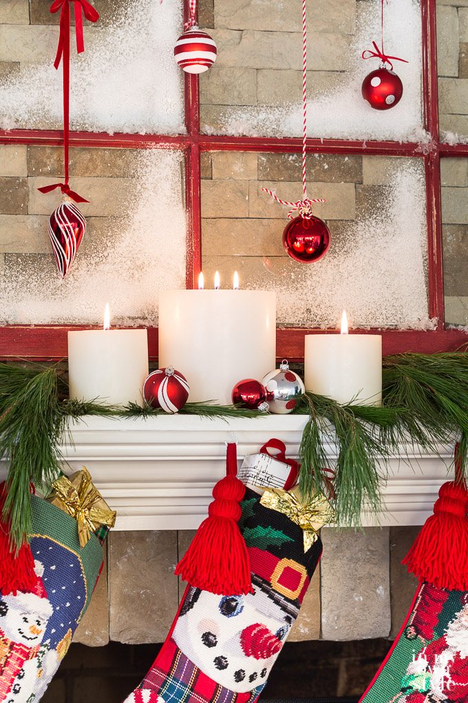 Pottery Barn pillar candles on a Christmas mantel