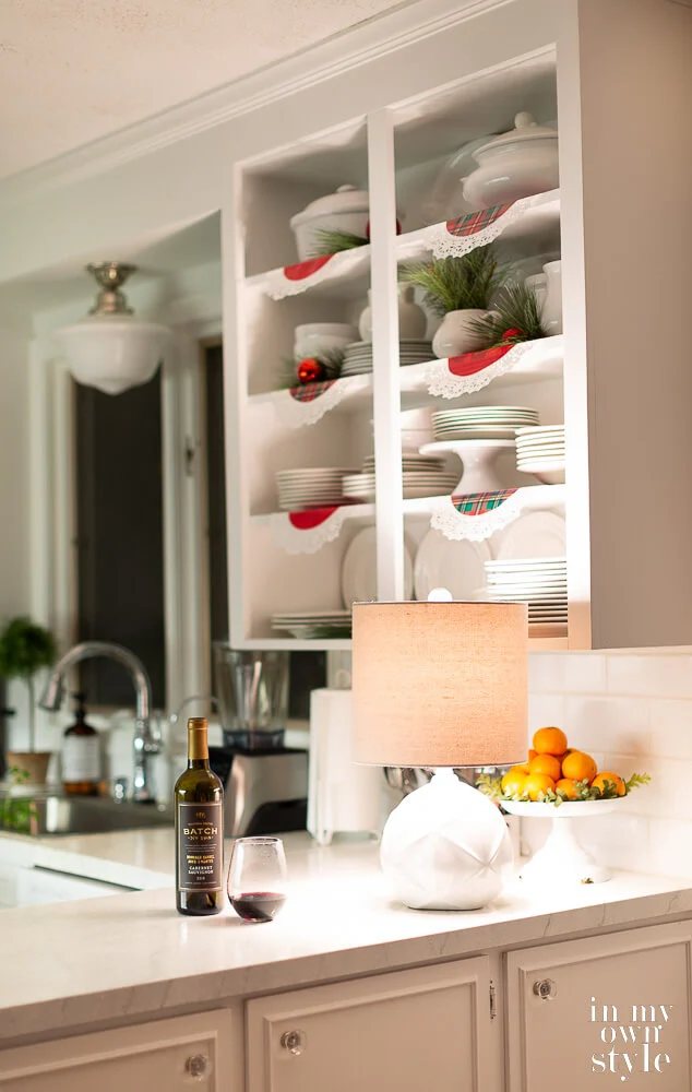 Small kitchen with a small lamp on counter to provide a cozy feel.