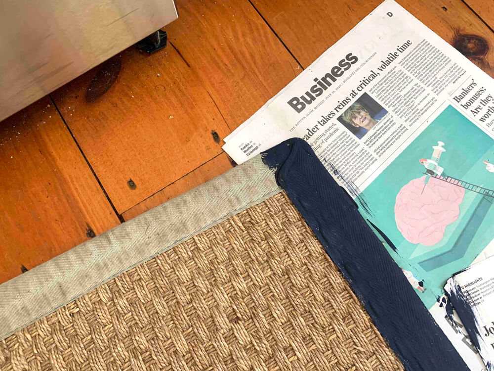 Blog reader sent photo showing how she was inspired by my rug border painting post and started it on her rug using navy paint.