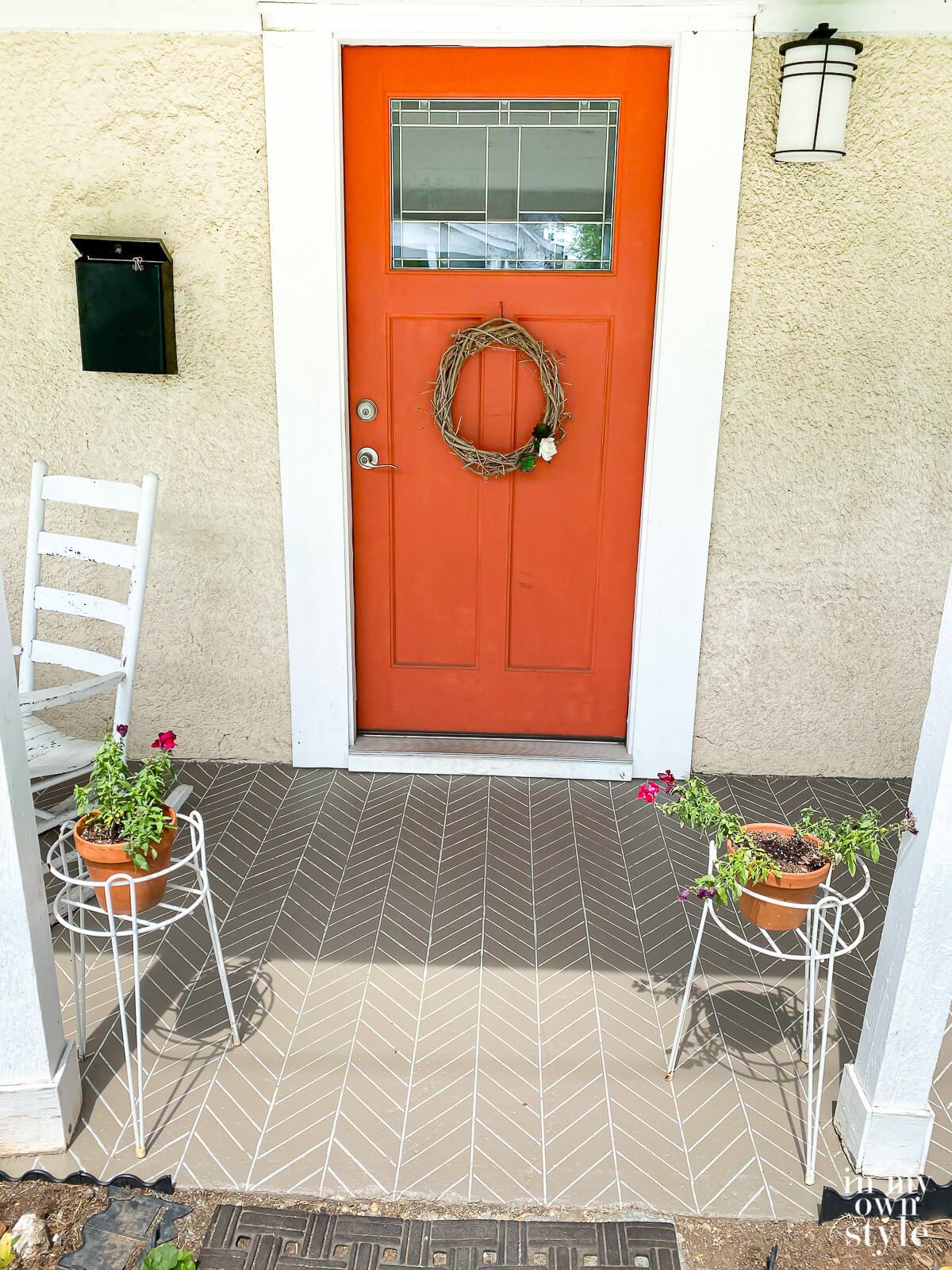 Outdoor concrete porch paint stencil on porch floor in herringbone pattern.