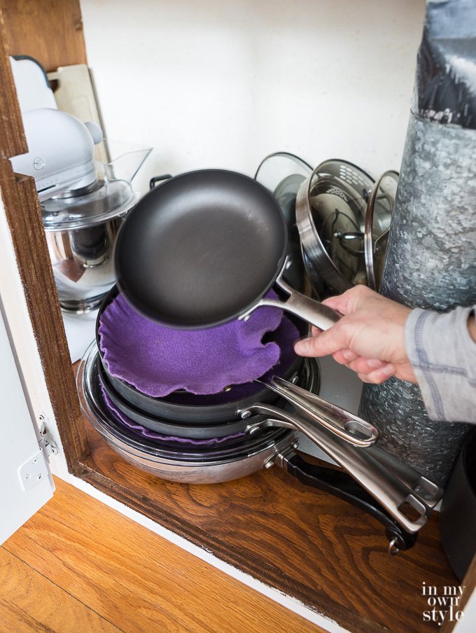 How to protect pots and pans from getting scratched when storing them in a kitchen cabinet.