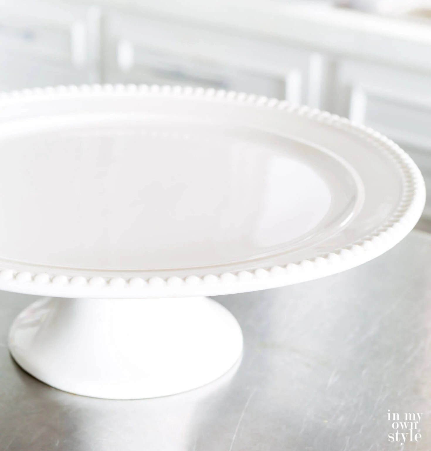 white cake plate with beaded edges can be repurposed for other uses.