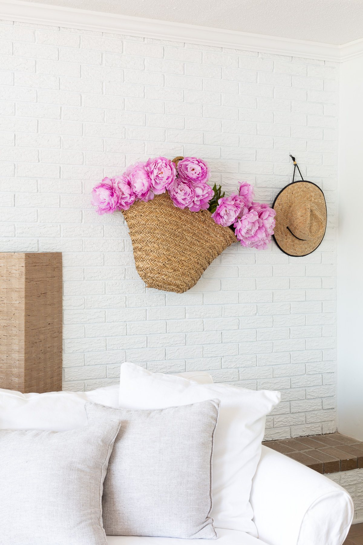 Flowers in a basket hung on a wall for simple summer decorating