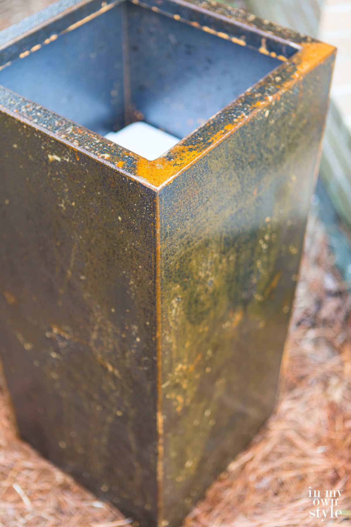 First coat of rust accelerator on surface of metal planter