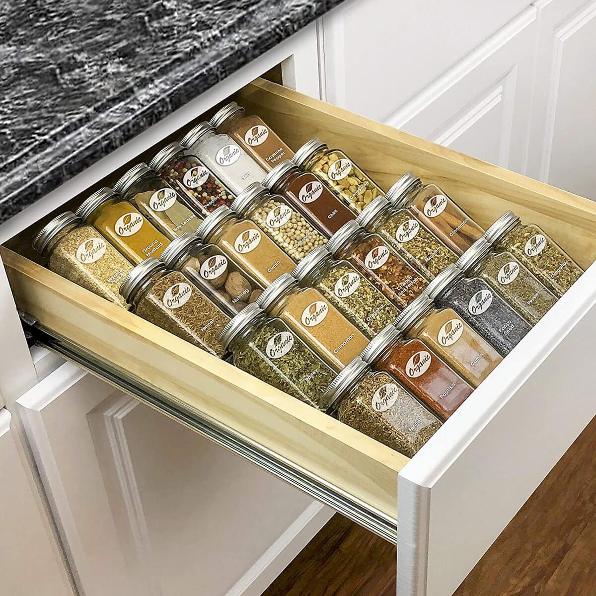 expandable wood spice rack in a kitchen drawer