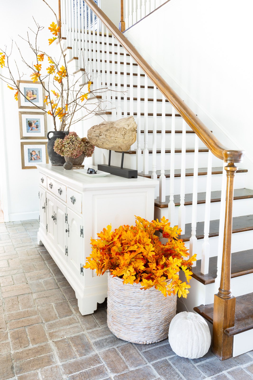 home entrance foyer decorated for fall with faux branches