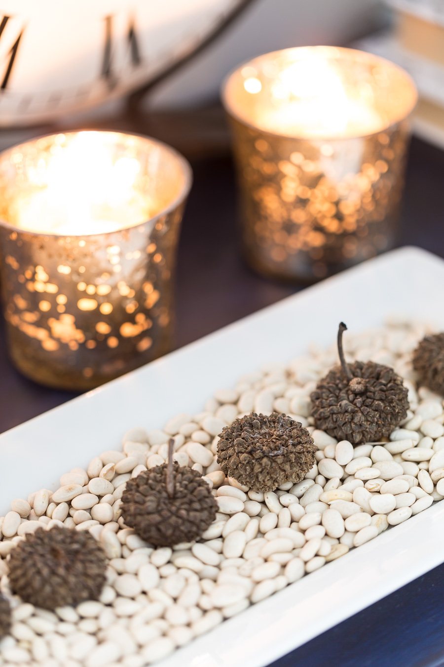 Nature inspired fall decor. Acorns on a tray of white beans.