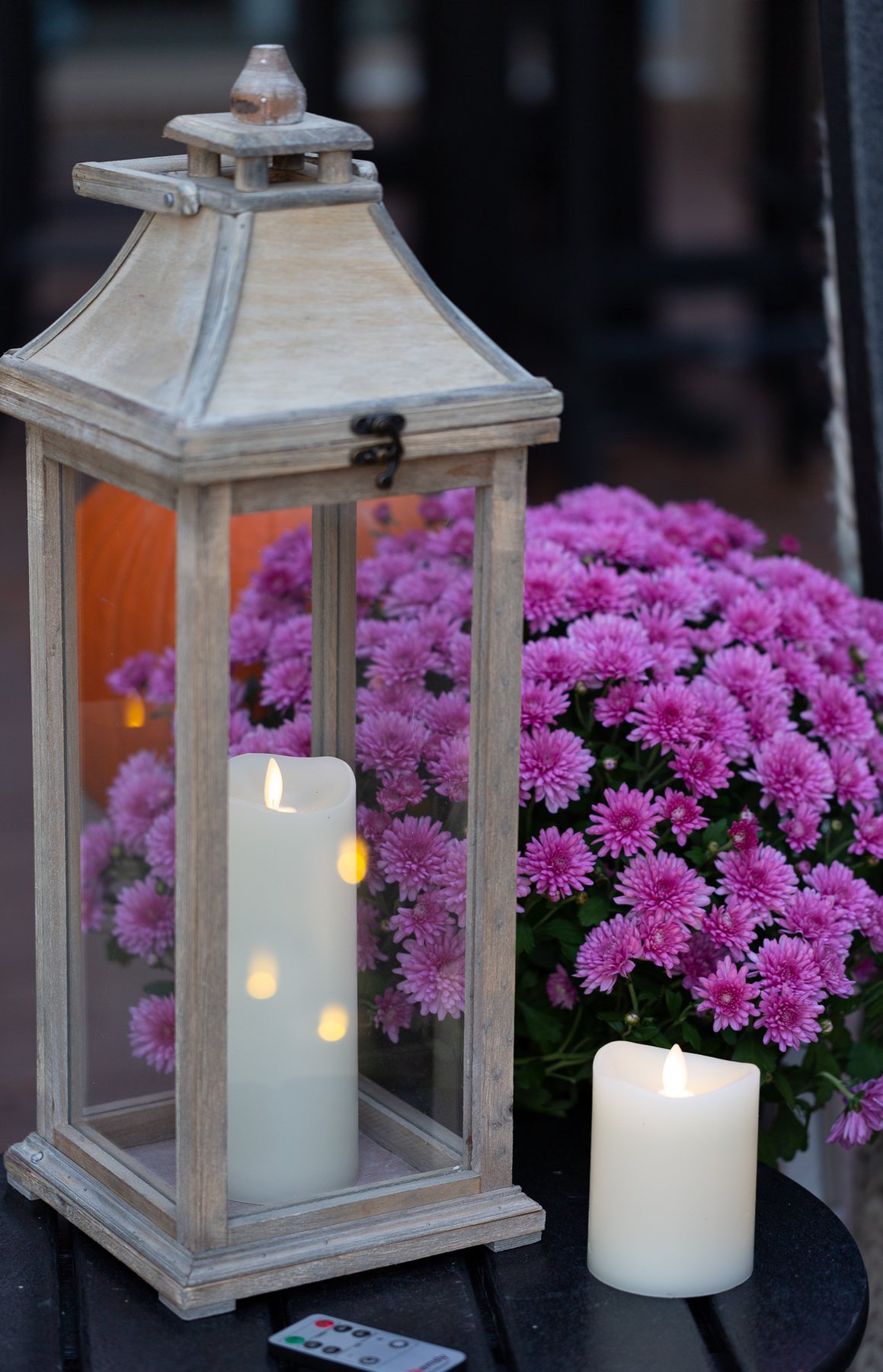 Wood candle lantern on fall decorated outdoor table