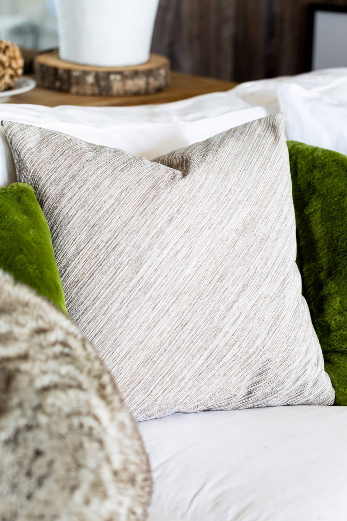 Plain side of no zipper pillow cover on a sofa.