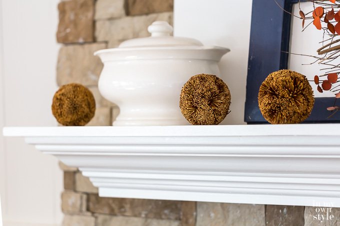 3 rustic balls lined up on autumn inspired mantel