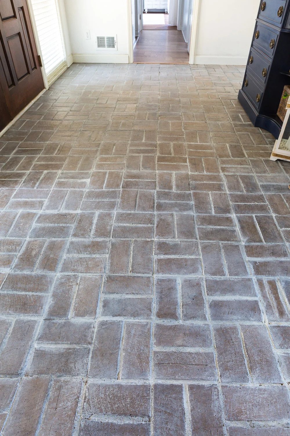 Close-up shot of whitewashed brick floor in entryway foyer.