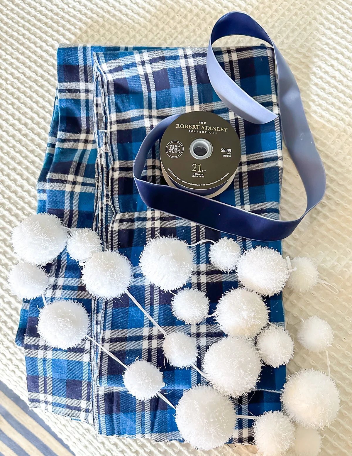 blue and white plaid fabric, blue ribbon and snowball garland.