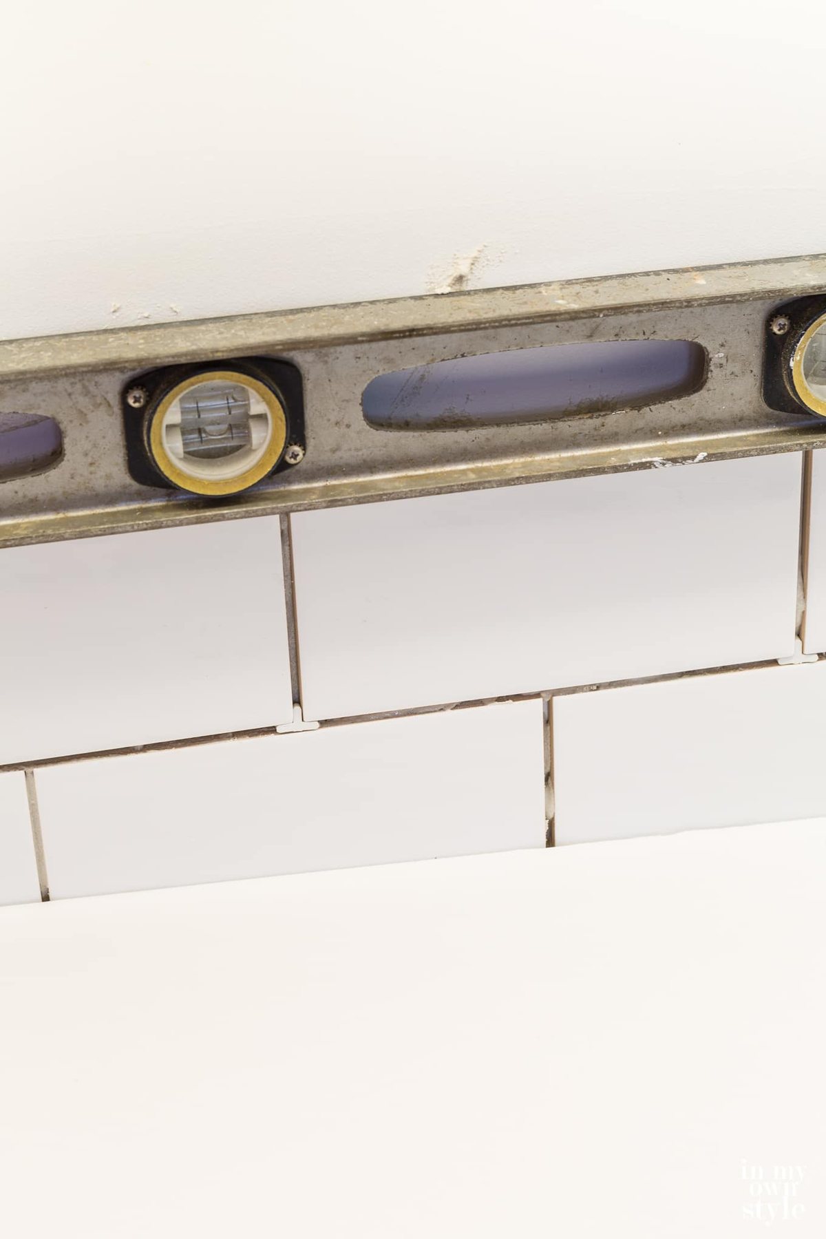 Subway tile installation on a kitchen backsplash