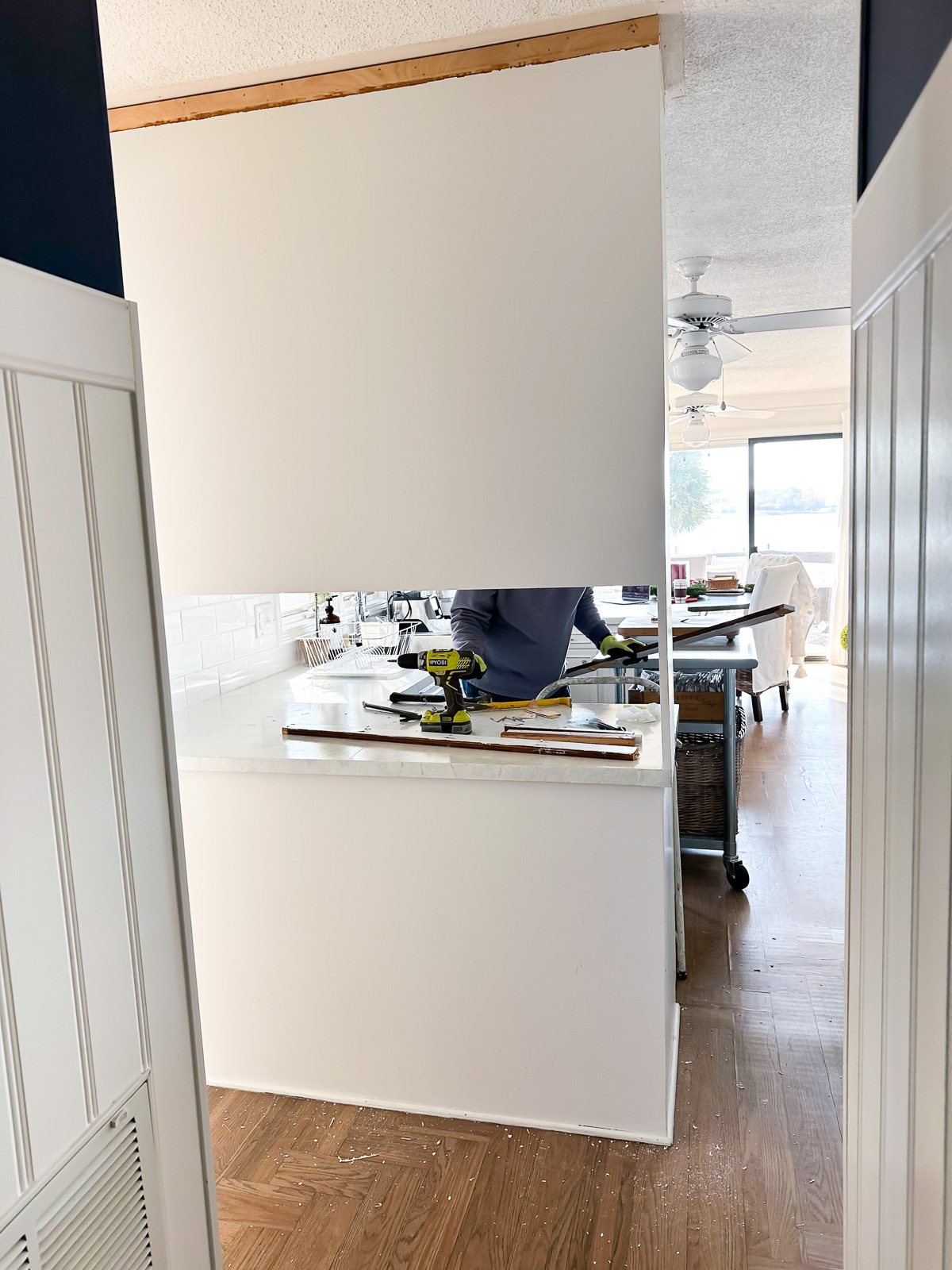 back of section of kitchen cabinets that block the view into the kitchen.