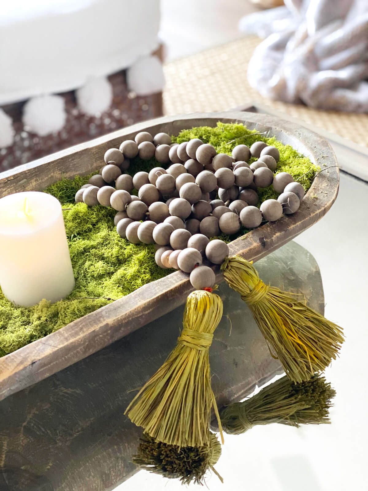 wood bead strand in a dough bowl on a coffee table