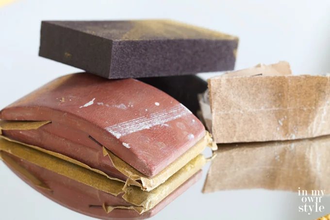 How-to-distress-a-piece-of-furniture using sand paper and sanding blocks.