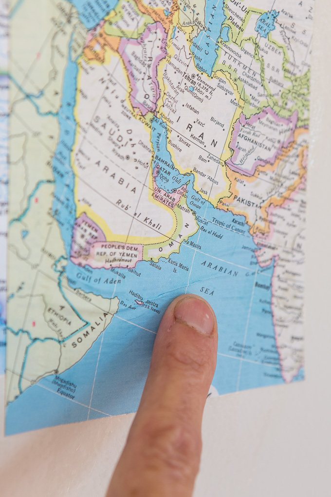DIY map wallpaper step by step tutorial that shows how to remove wrinkles that may appear when applying maps and or paper to walls